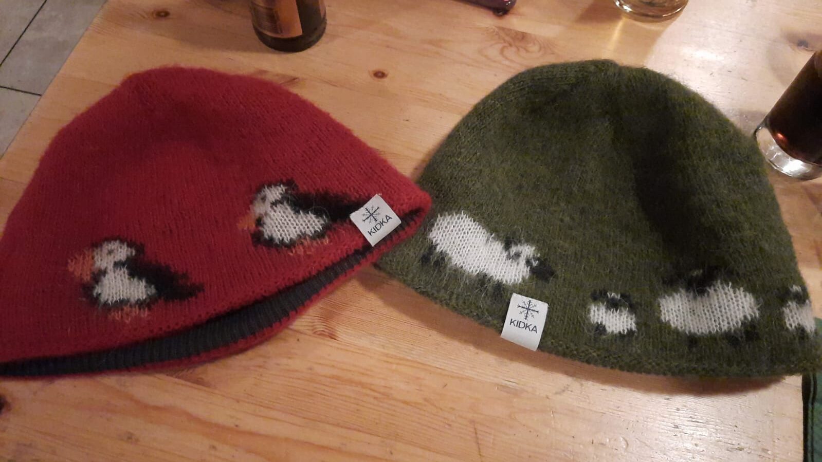 A red with puffins and a green with sheep wool hats