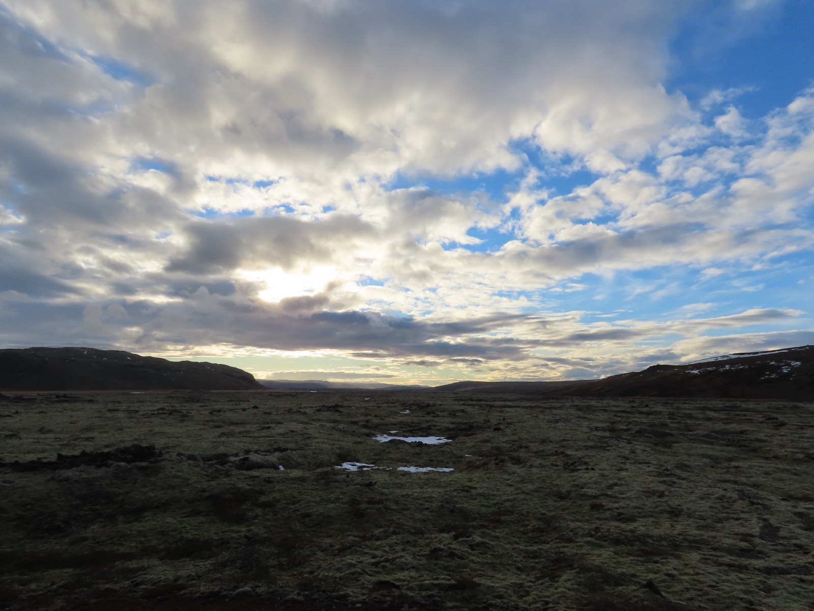 With moss covered lavafield and a cloudy sky