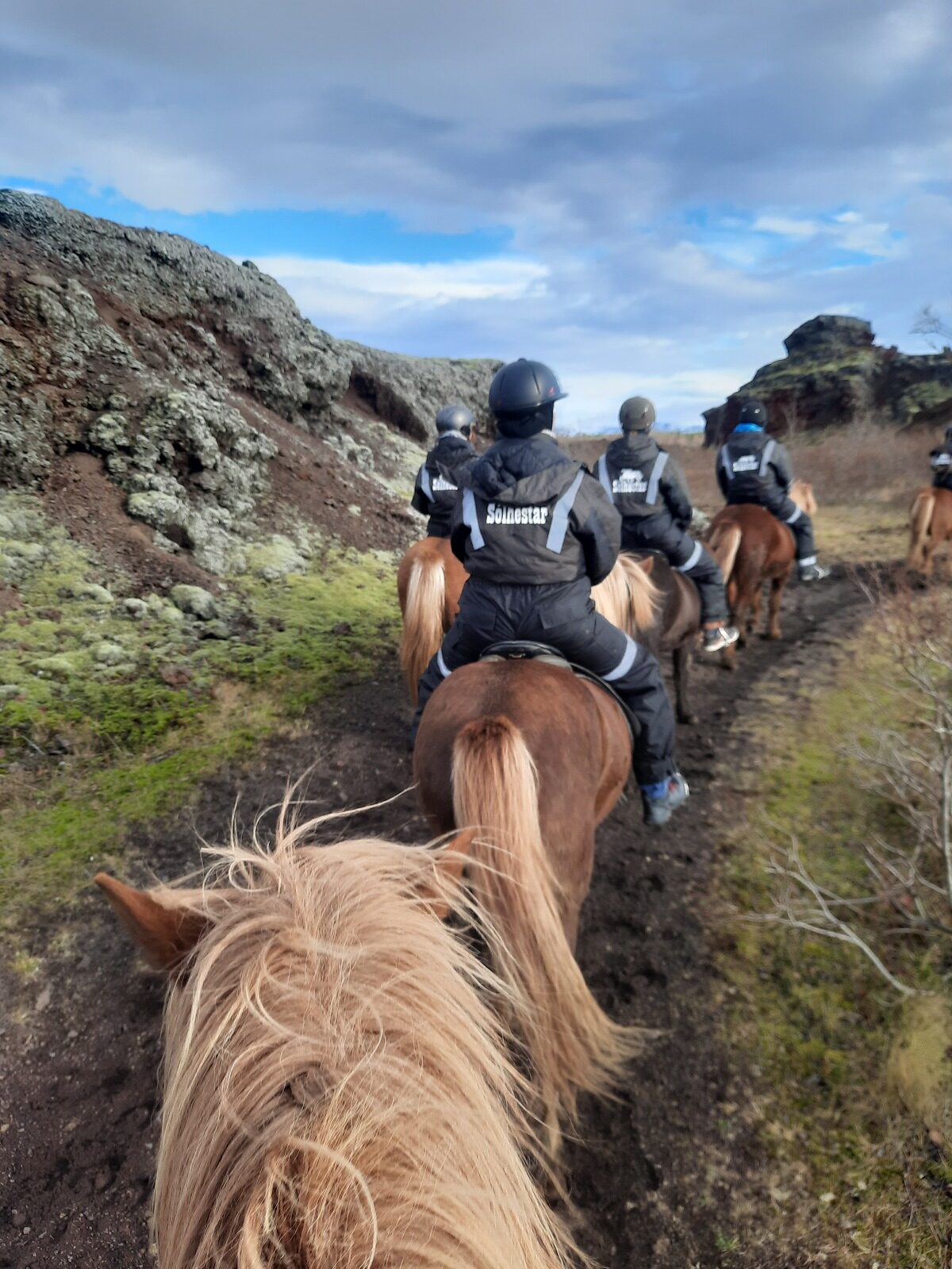 View from a horses back looking at other riders